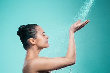 Image showing Woman enjoying water in the shower under a jet