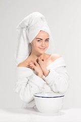 Image showing Young woman washing face with clean water