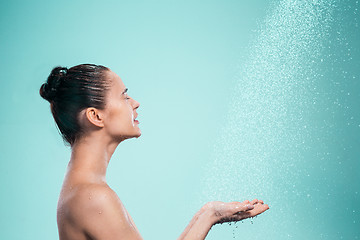 Image showing Woman enjoying water in the shower under a jet