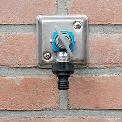 Image showing Faucet in a brick wall