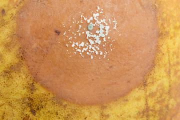 Image showing Pear with white area of fungus growing on it, selective focus