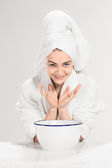 Image showing Young woman washing face with clean water