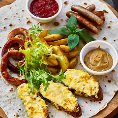 Image showing Grilled sausages and vegetables  in rustic style. 