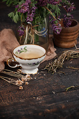 Image showing Tea with  lemon and bouquet of primroses on the table