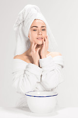 Image showing Young woman washing face with clean water