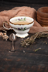 Image showing Tea with  lemon and dried flowers on the table