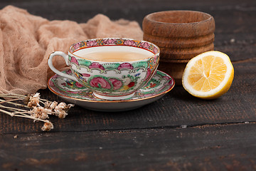 Image showing Tea with  lemon and primroses on the table