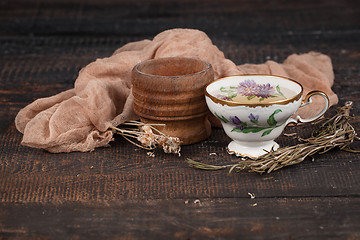 Image showing Tea with  lemon and dried flowers on the table