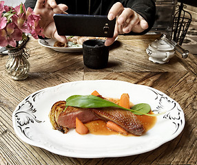 Image showing taking photo of duck fillet portion with smart phone