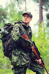 Image showing young soldier or hunter with gun in forest