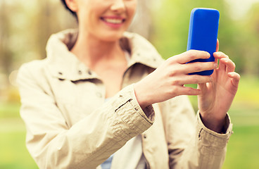 Image showing close up of woman taking picture with smartphone