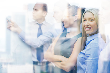 Image showing business team with flip board having discussion