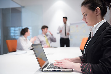 Image showing young business woman on meeting  using laptop computer