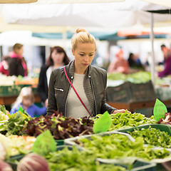 Image showing Woman buying vegetable at local food market. 