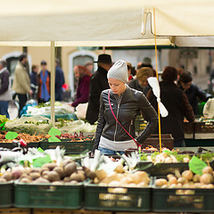 Image showing Woman buying vegetable at local food market. 