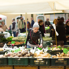 Image showing Woman buying vegetable at local food market. 