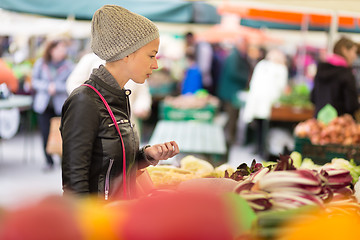 Image showing Woman buying vegetable at local food market. 