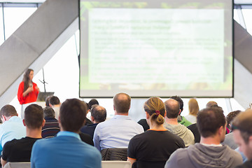 Image showing Female speeker having talk at public event.