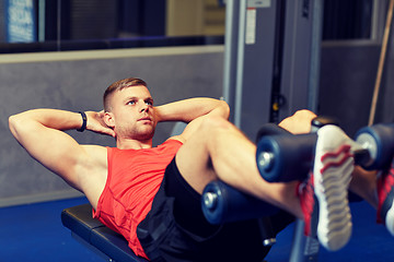 Image showing young man making abdominal exercises in gym