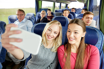 Image showing women taking selfie by smartphone in travel bus