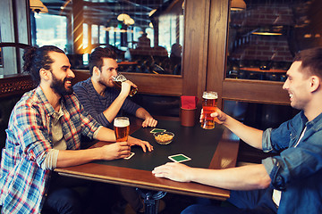 Image showing happy male friends drinking beer at bar or pub