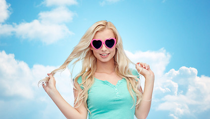 Image showing happy young woman in heart shape sunglasses