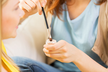 Image showing woman visagist applying eyeshade by makeup brush 