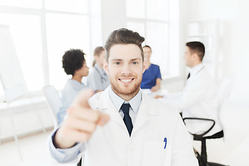 Image showing happy doctor over group of medics at hospital