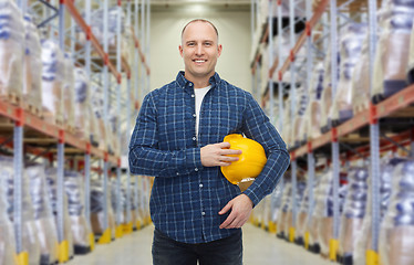 Image showing happy man with hardhat over warehouse