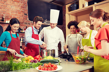 Image showing happy friends and chef cook cooking in kitchen