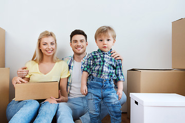 Image showing happy family with boxes moving to new home