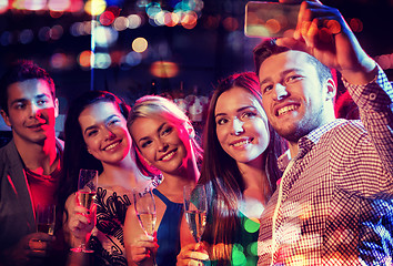 Image showing friends taking selfie by smartphone in night club