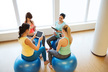 Image showing happy pregnant women with gadgets in gym