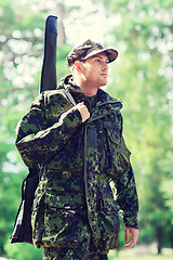 Image showing young soldier or hunter with gun in forest