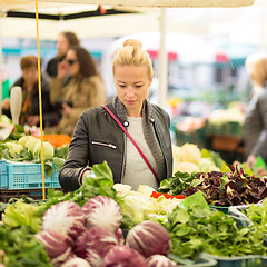 Image showing Woman buying vegetable at local food market. 