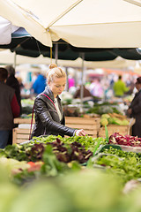 Image showing Woman buying vegetable at local food market. 