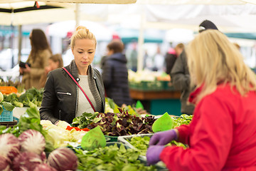 Image showing Woman buying vegetable at local food market. 