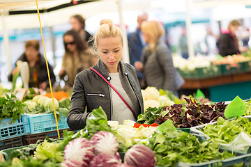 Image showing Woman buying vegetable at local food market. 