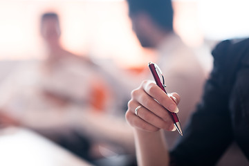 Image showing woman hands holding pen on business meeting