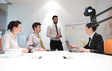 Image showing business people group brainstorming and taking notes to flip boa