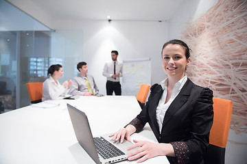 Image showing young business woman on meeting  using laptop computer