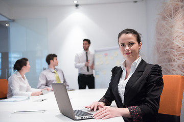 Image showing young business woman on meeting  using laptop computer