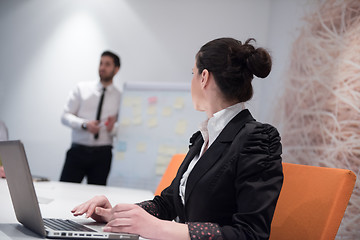 Image showing young business woman on meeting  using laptop computer