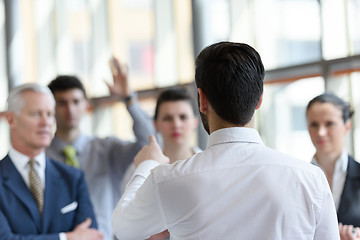 Image showing young startup businessman making presentation to senior investio