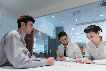 Image showing young couple signing contract documents on partners back