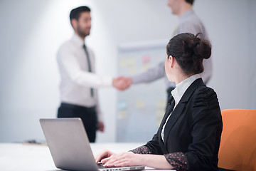 Image showing young business woman on meeting  using laptop computer