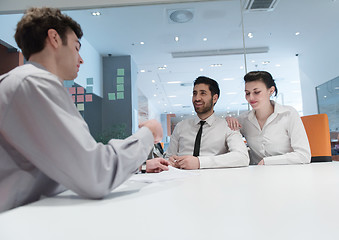 Image showing young couple signing contract documents on partners back