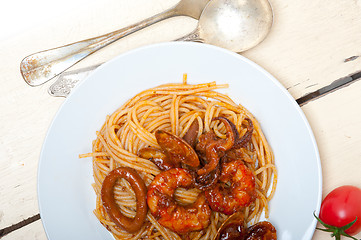 Image showing Italian seafood spaghetti pasta on red tomato sauce 