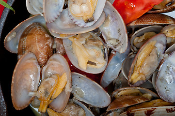 Image showing fresh clams on an iron skillet