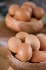 Image showing Fresh eggs at wooden plate 